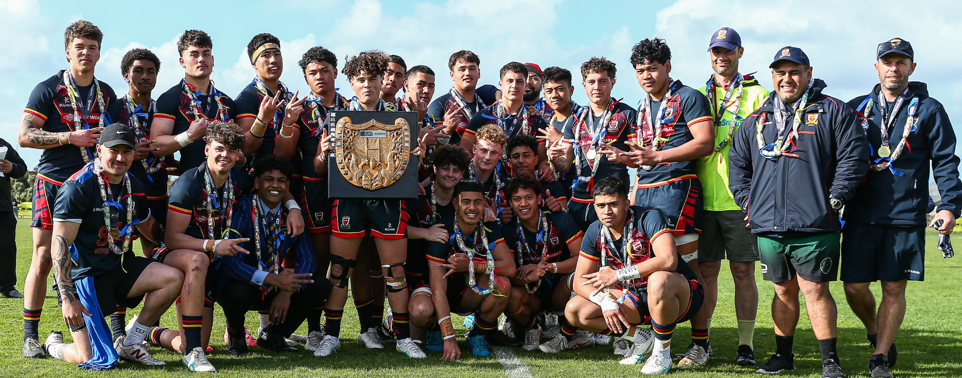 St Thomas rugby league team holding trophy