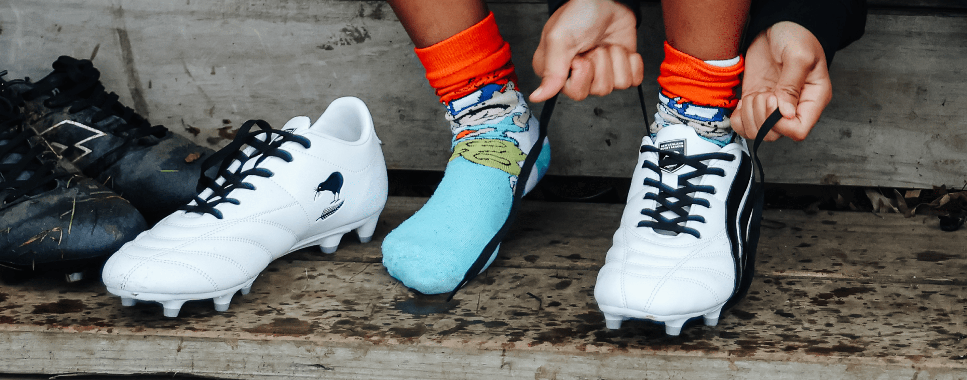 Child tying rugby league boots laces